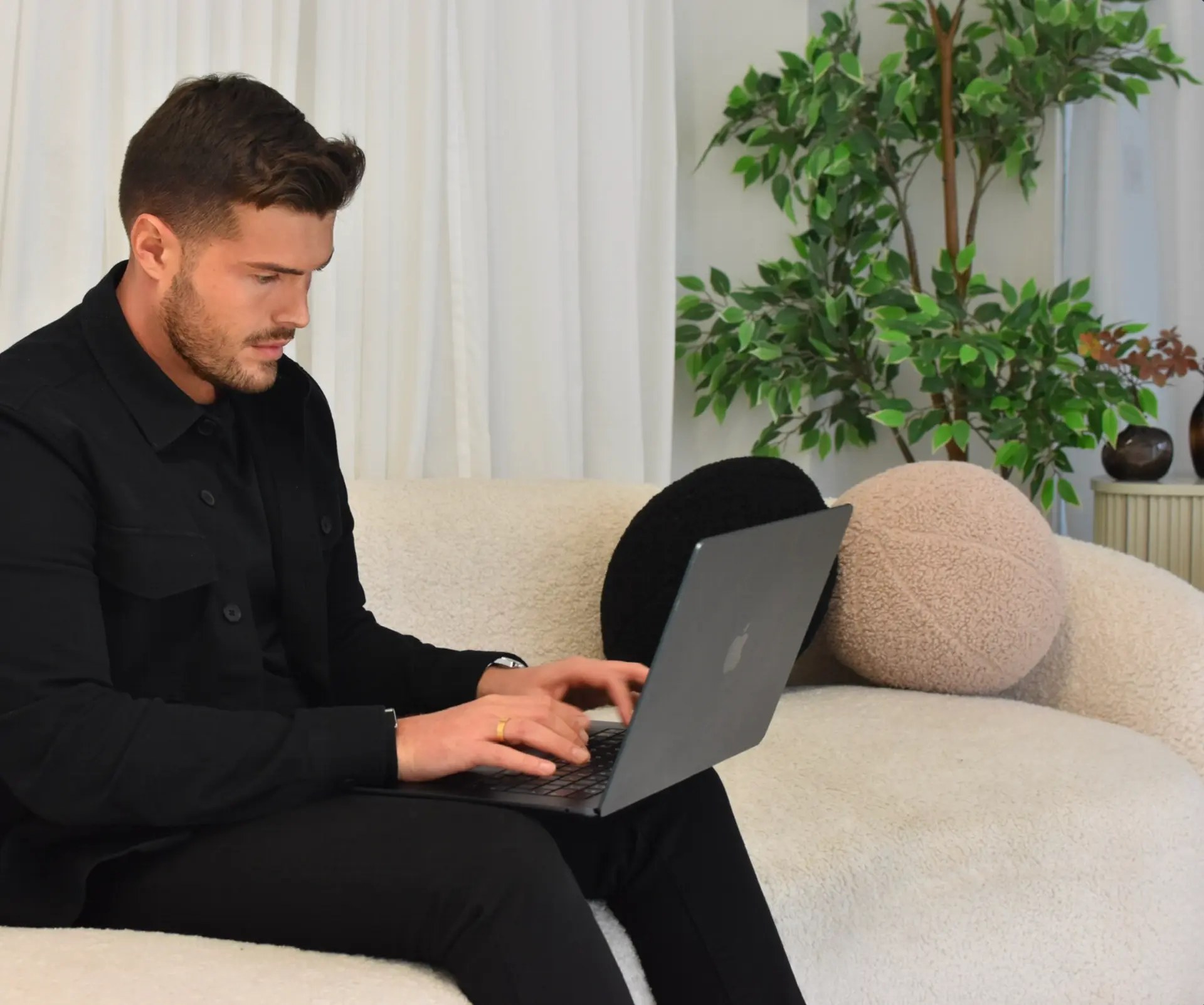 Max Harrington, founder of MX Web Design, working on a client website